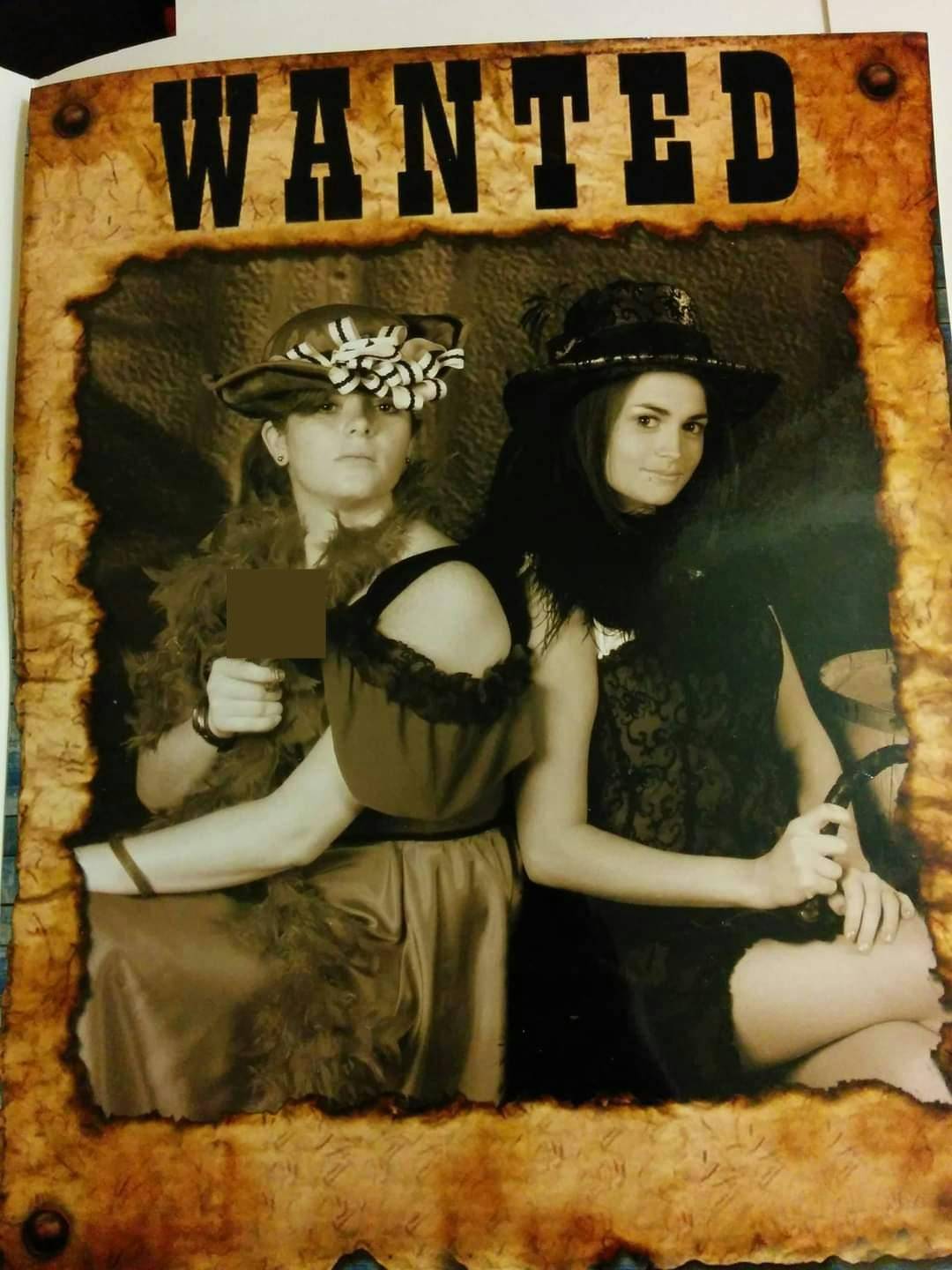 A picture of a western-style poster that says "Wanted" with Allison in a ridiculous oversized hat and her sister somehow looking cute.