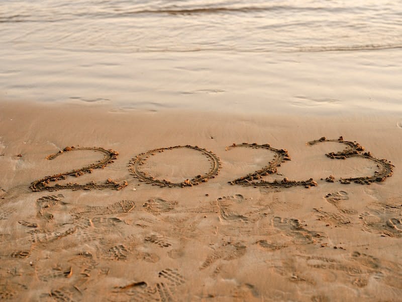 Writing 2023 on sand beach