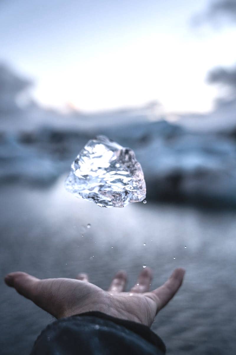 person throwing crystal stone