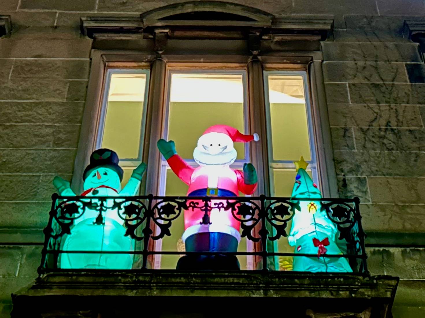 Photo of inflatable Santa, snowman and Christmas tree on a Georgian balcony