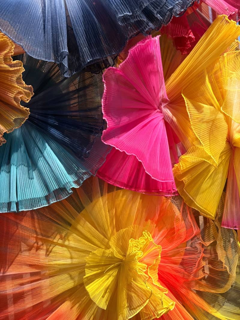 Abstract display of colorful pleated fabric ruffles.