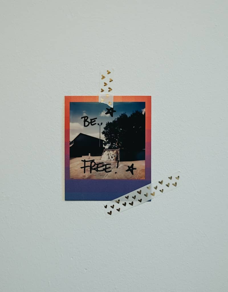Instant photo with "be free!" written on it.