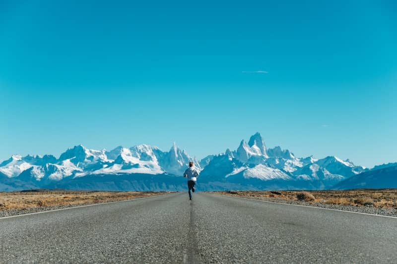 person running on road at daytime