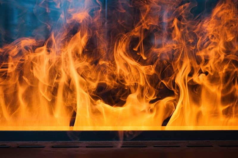 Vibrant orange flames dance against a dark background.