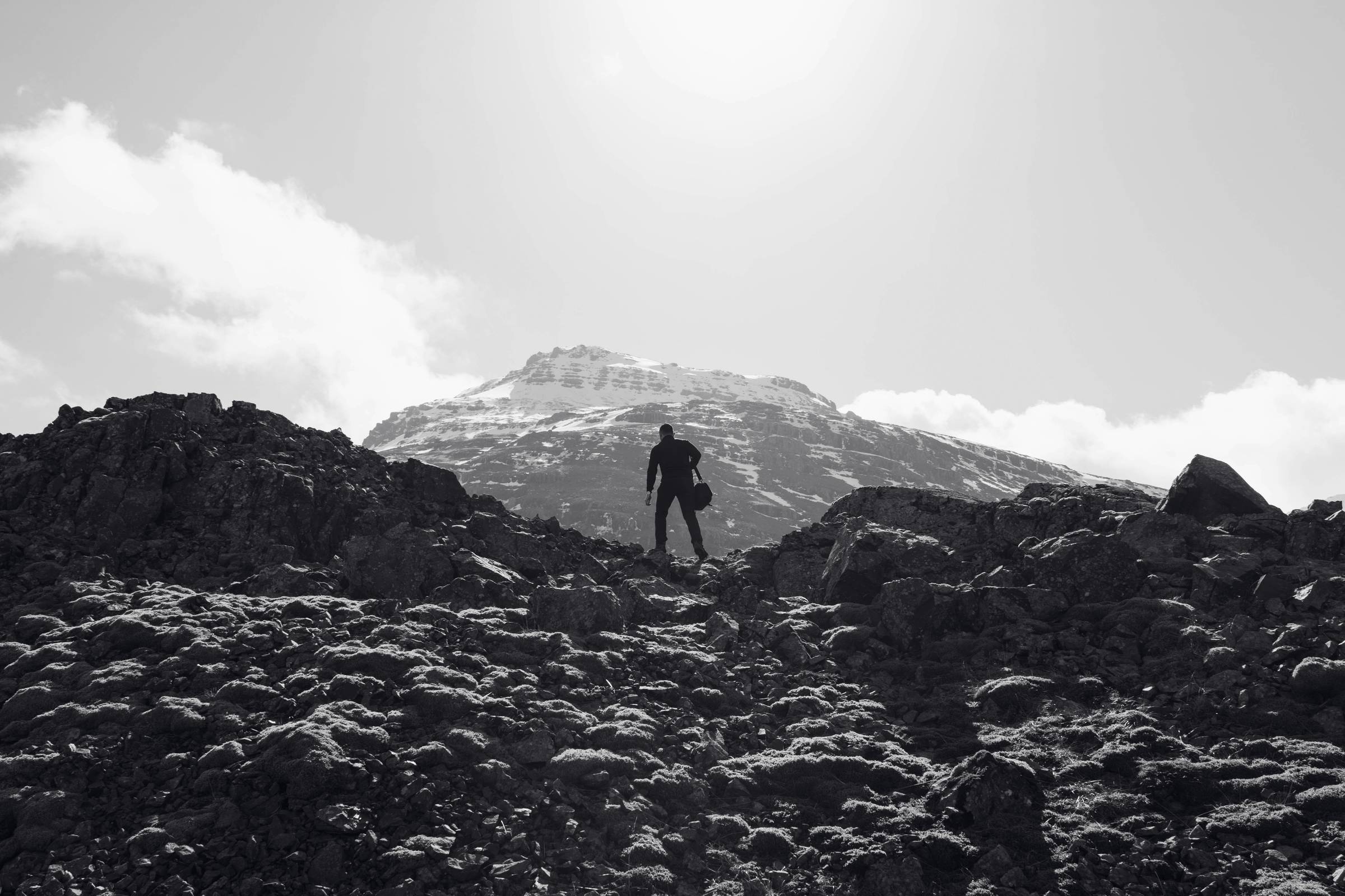 man climbing a rocky mountain