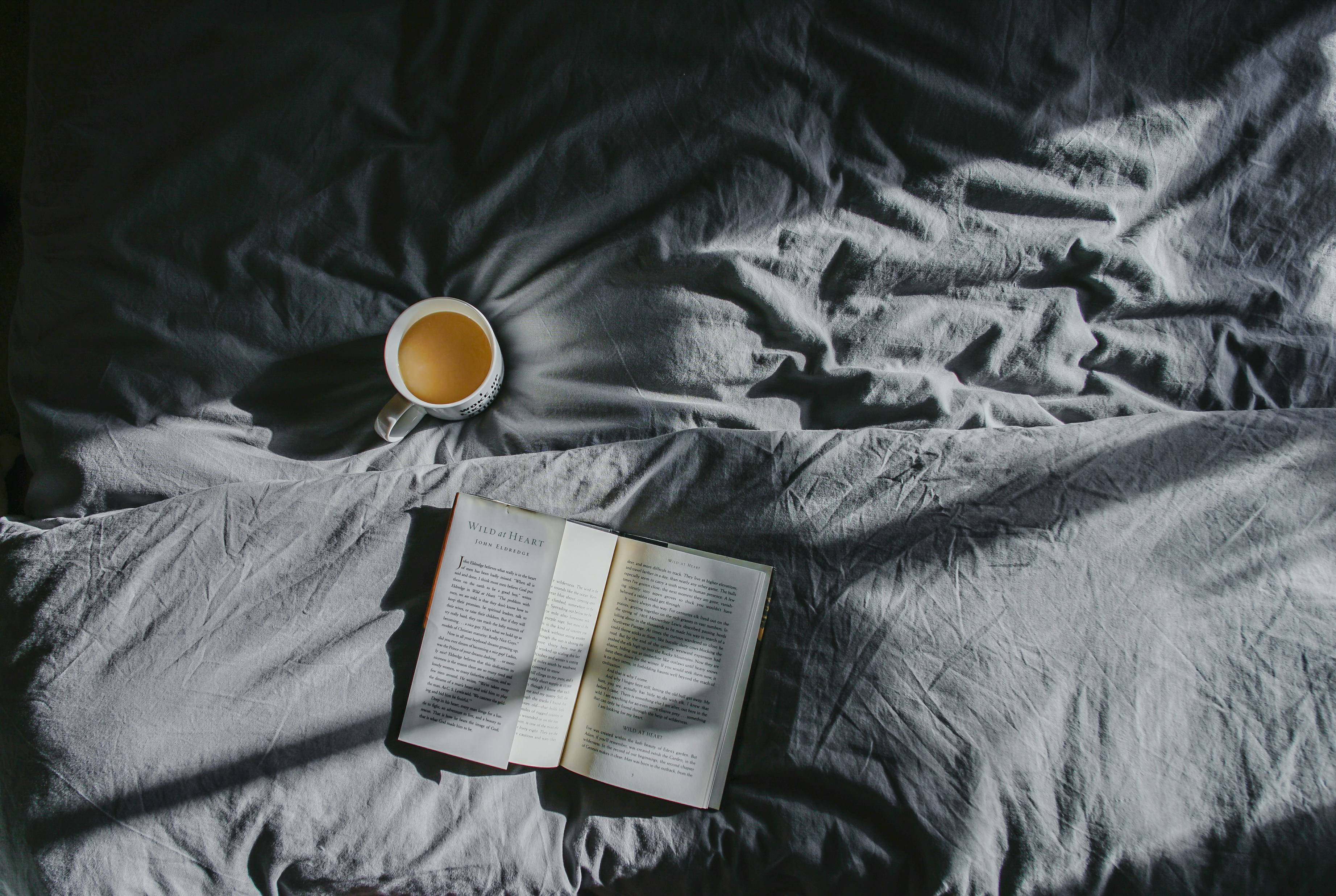 book and coffee in bed