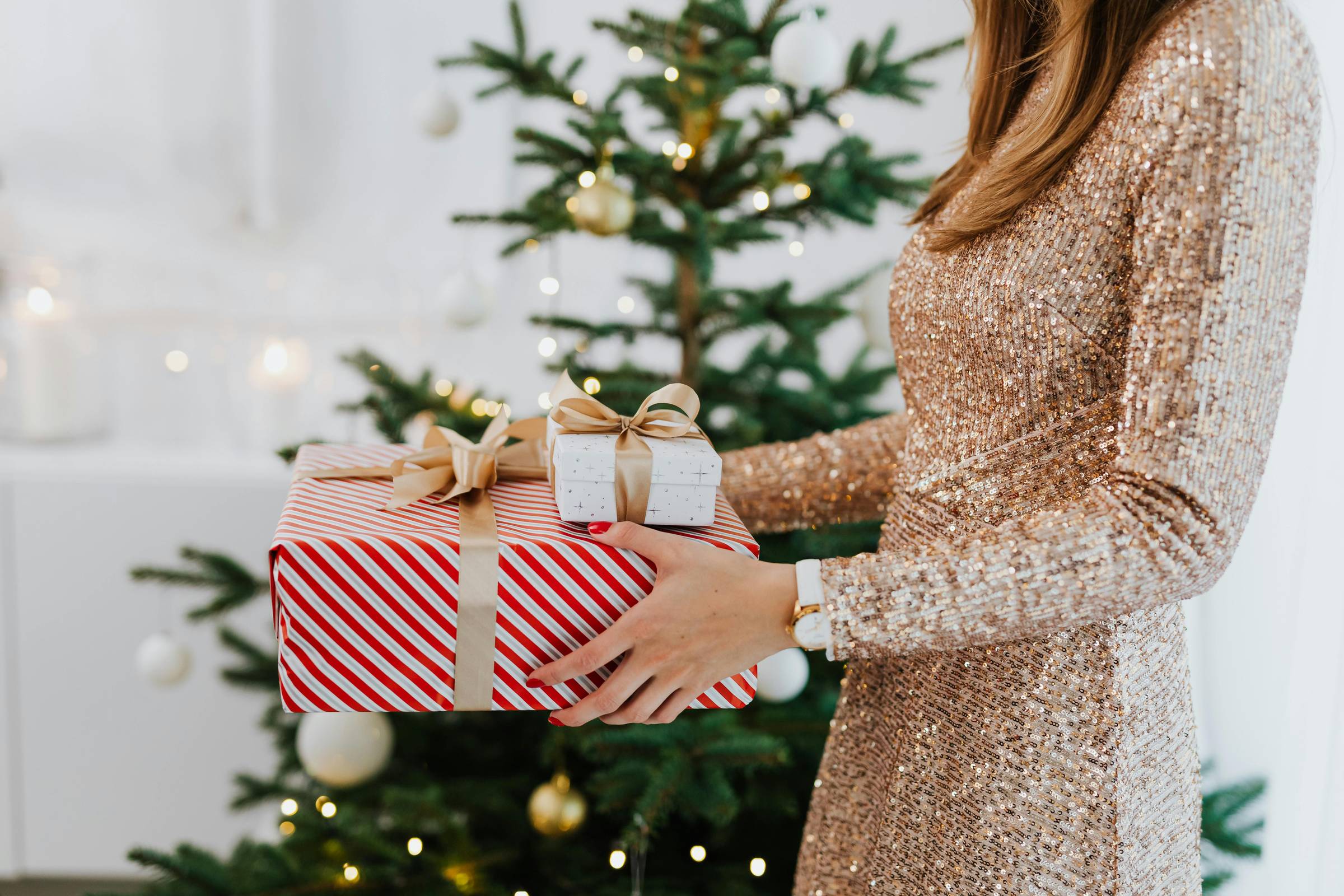 A woman holding christmas presents