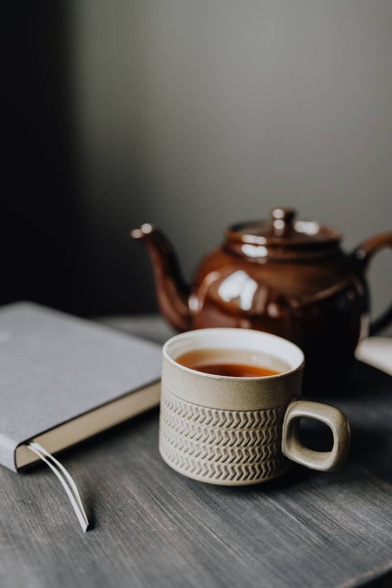 A cup of tea and a book on a table