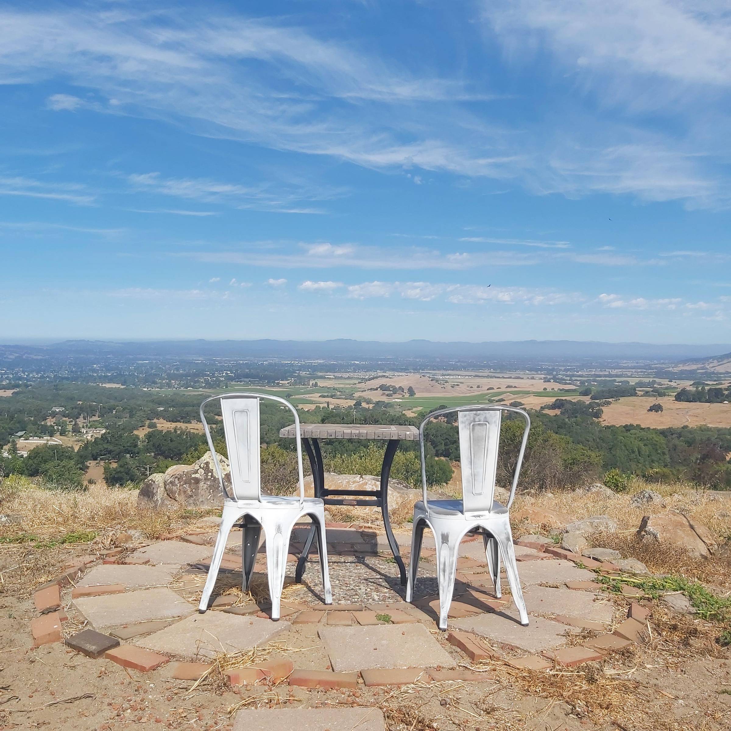 two empty chairs overlooking a beautiful valley