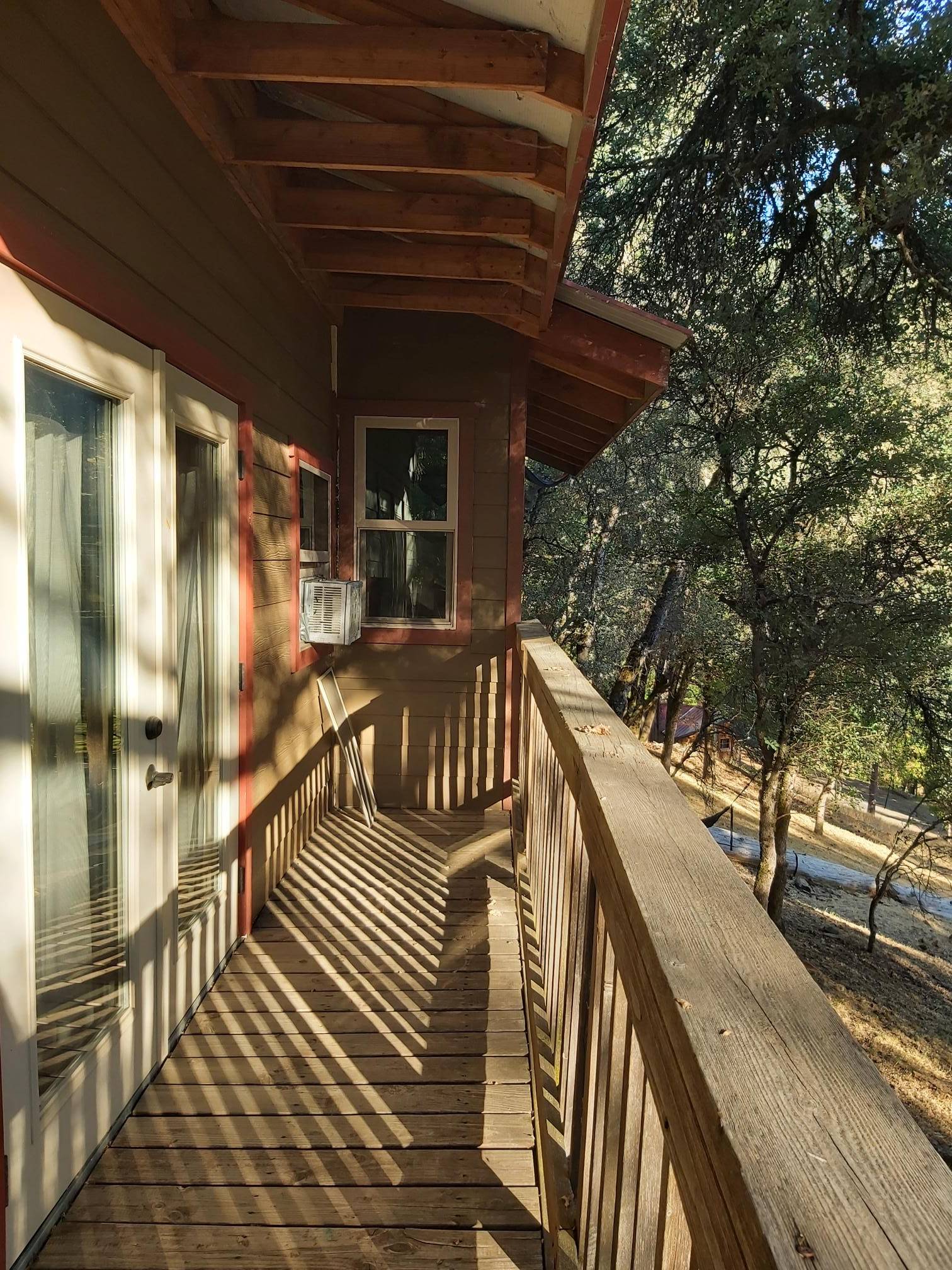 sunlight cabin balcony in the woods