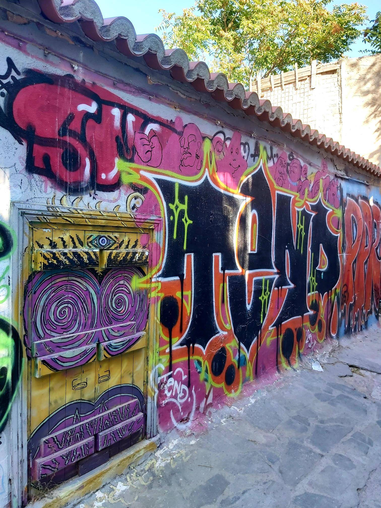 bold coloured graffiti on a concrete wall