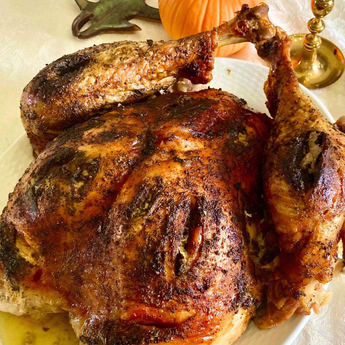 A roasted turkey on a large serving platter.