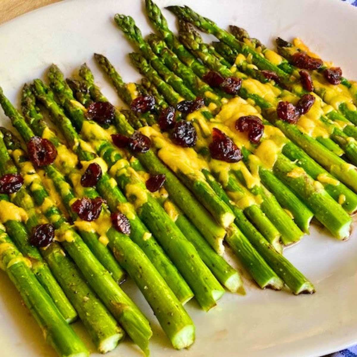 Cheesy balsamic asparagus on a serving plate.