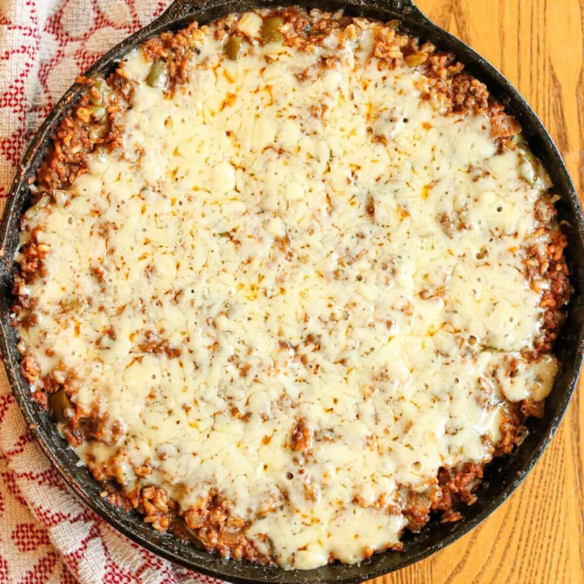 Deconstructed stuffed peppers skillet with melted parmesan.