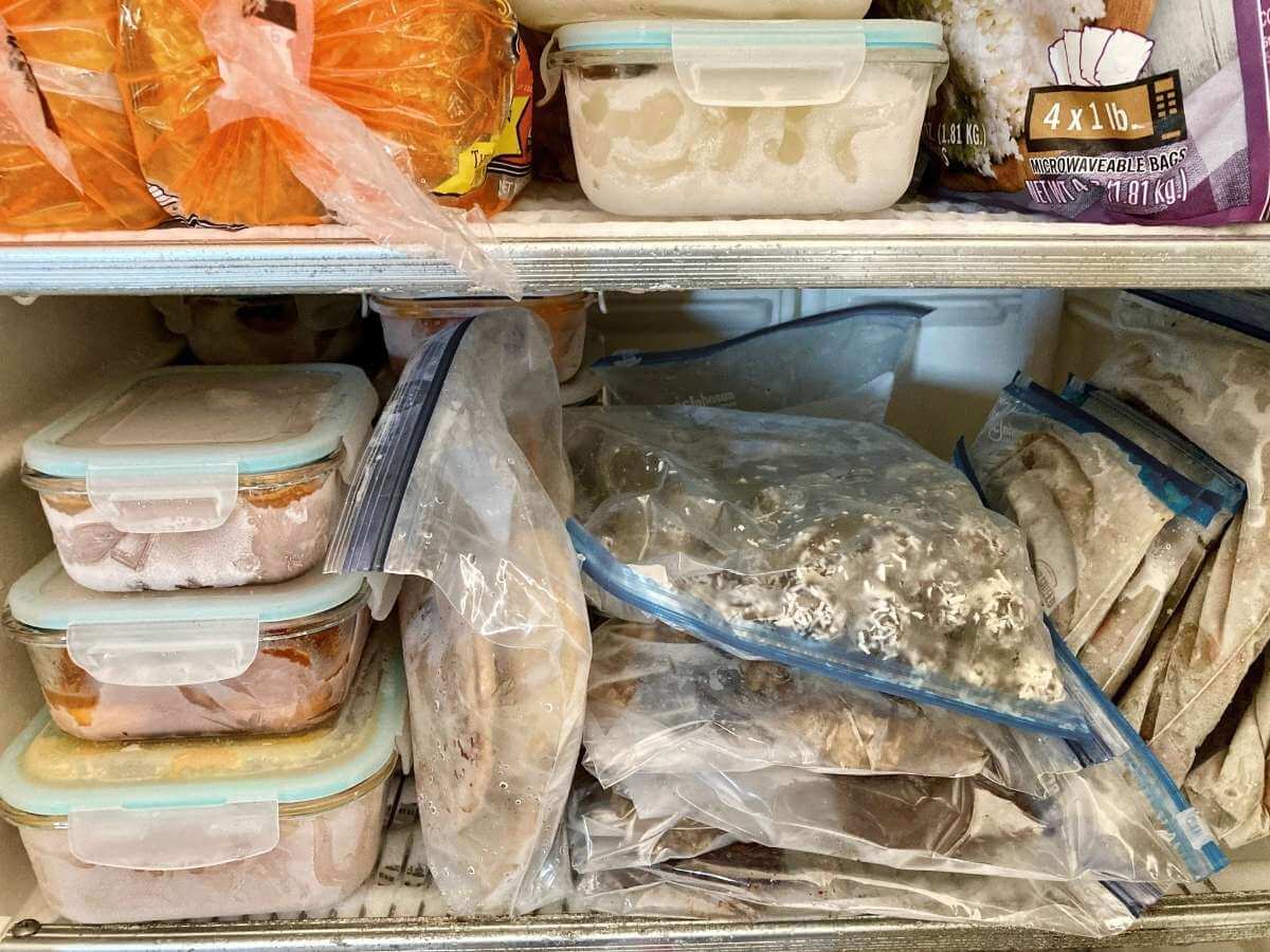 Freezer shelves packed with frozen meals.