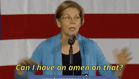 Senator Warren talking at a podium and spreader her hands out as she says, "Can I have an amen on that?"