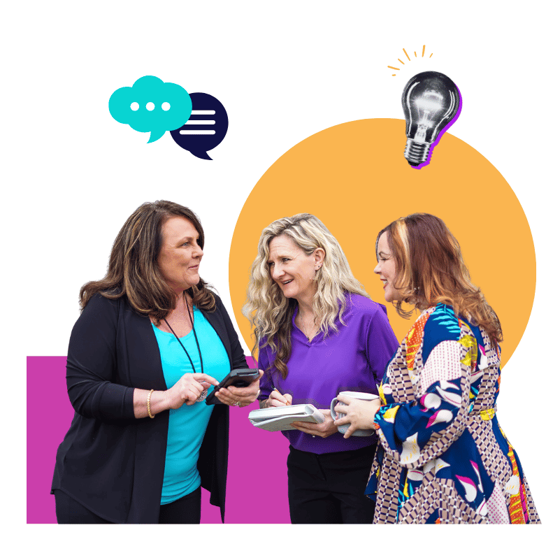 three women chatting while holding coffee, a notebook, and a phone