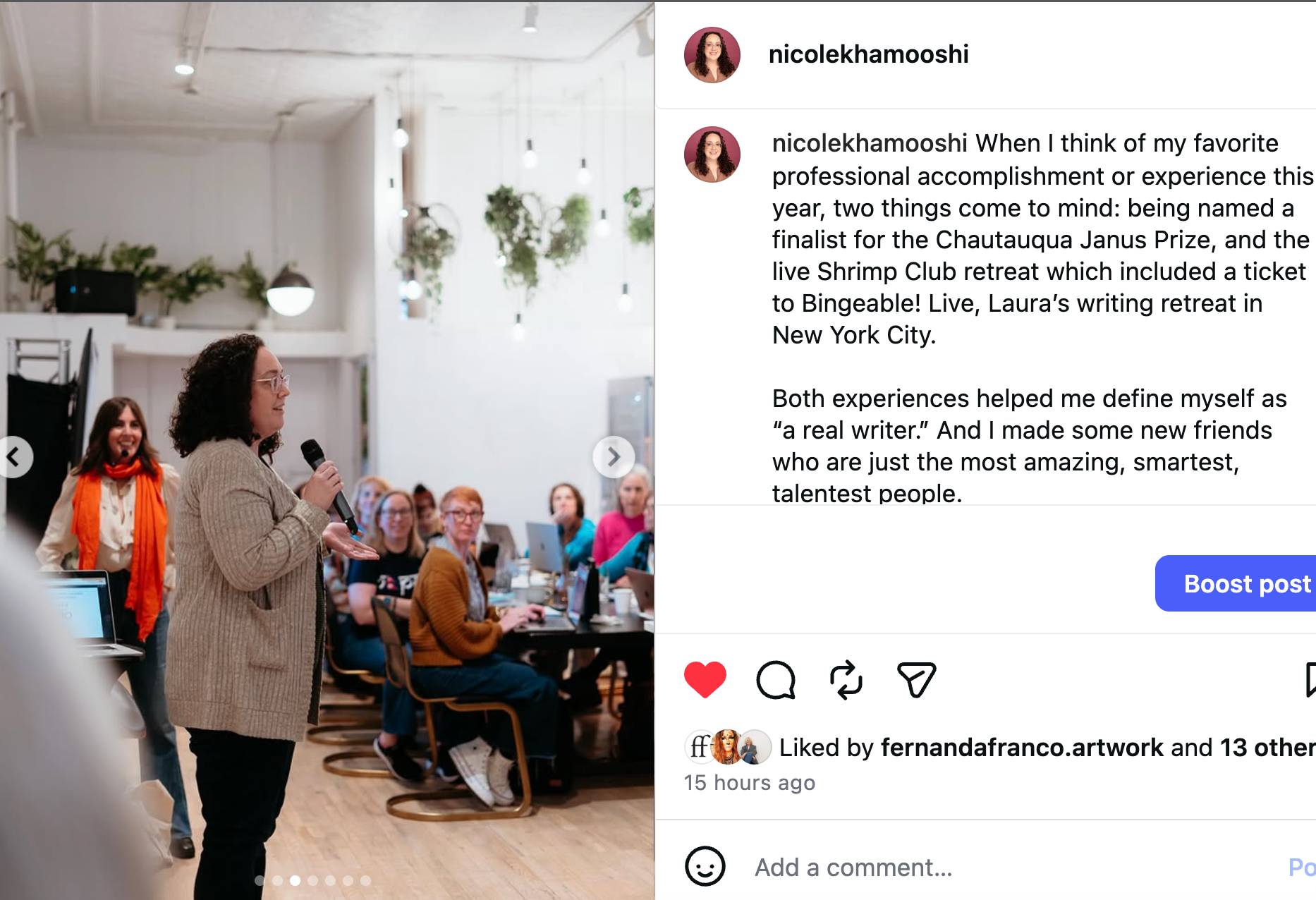 Instagram post showing Nicole Khamooshi, a person with shoulder length curly dark hair, speaking into a microphone at a writing retreat while attendees sit at tables with laptops. The caption reflects on professional accomplishments and finding community as a writer.