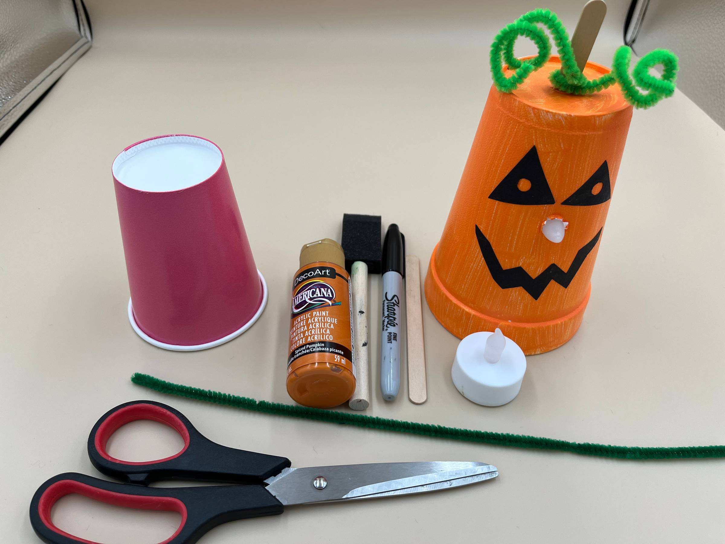 Paper cup jack-o-lantern and the supplies to make it