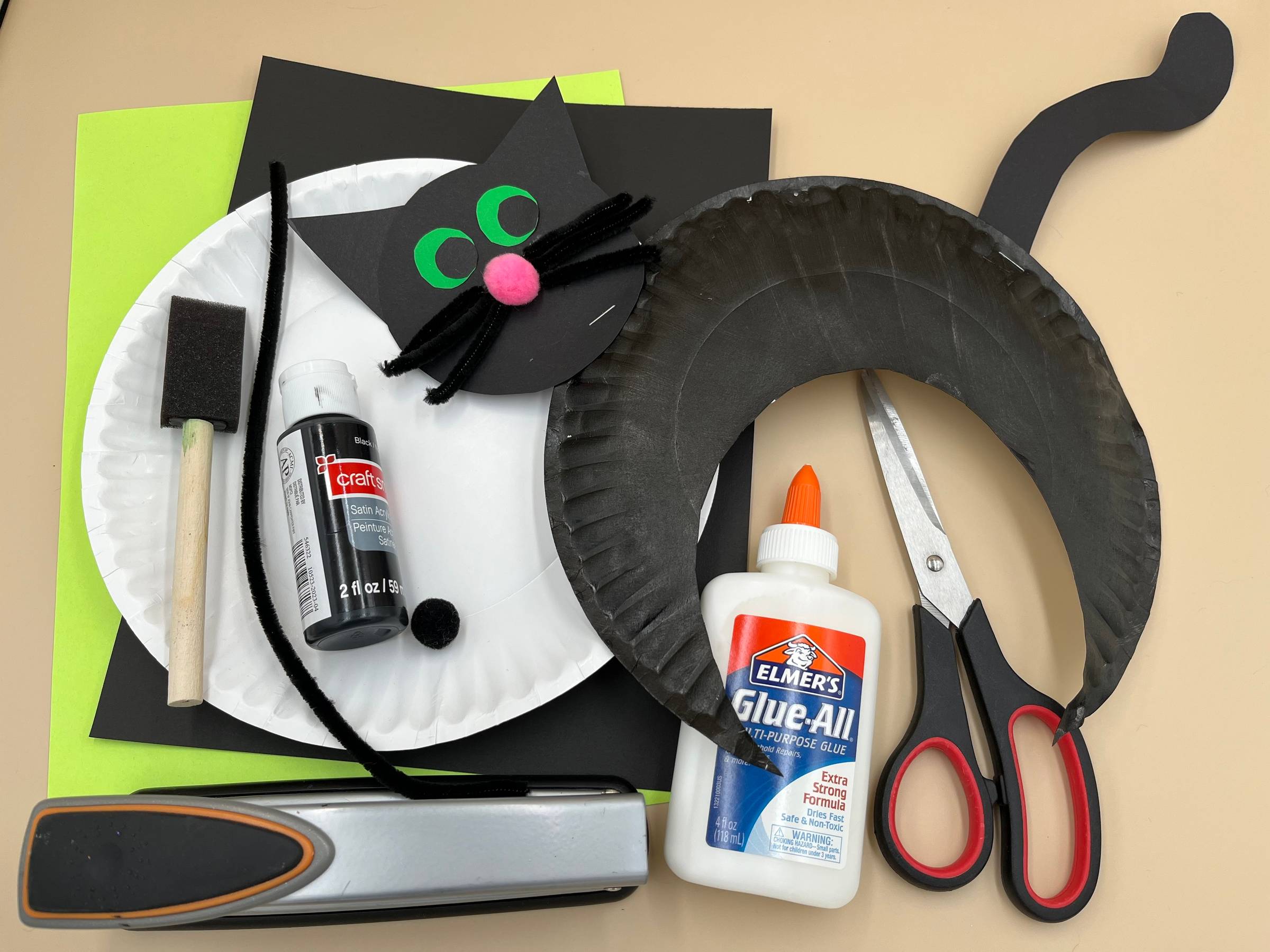 Paper plate black cat craft and the supplies needed to make it