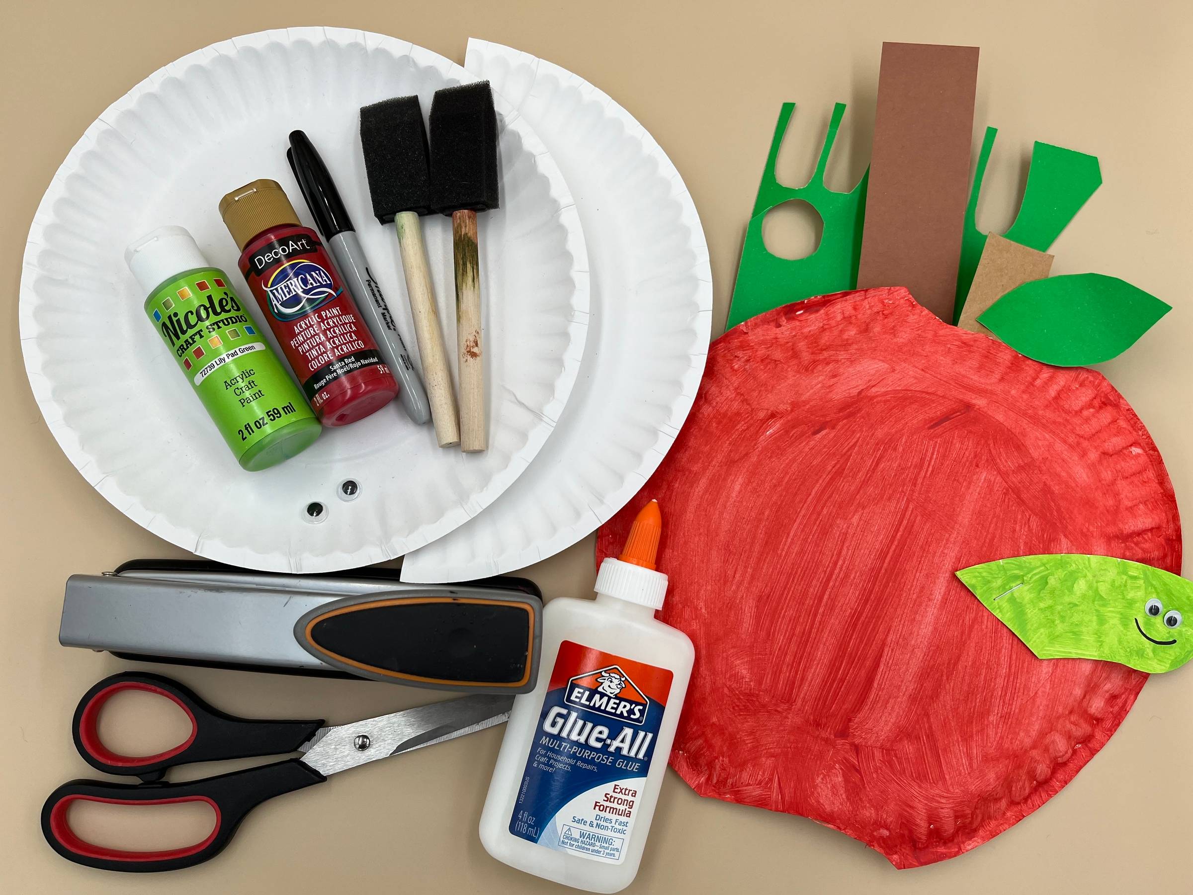 Paper Plate Apple craft and the supplies needed to make it