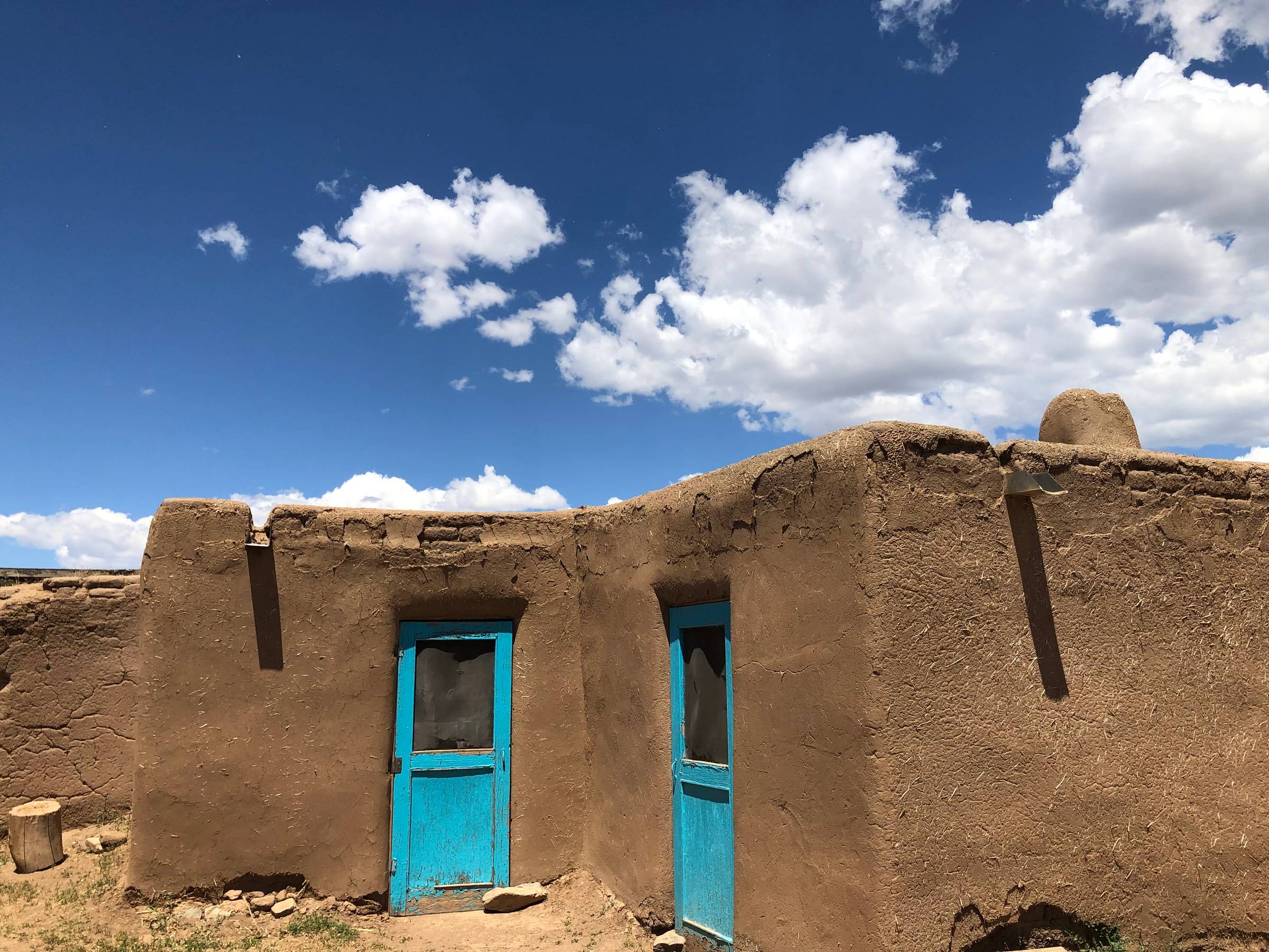  A pueblo building with blue doors near Taos, New Mexico