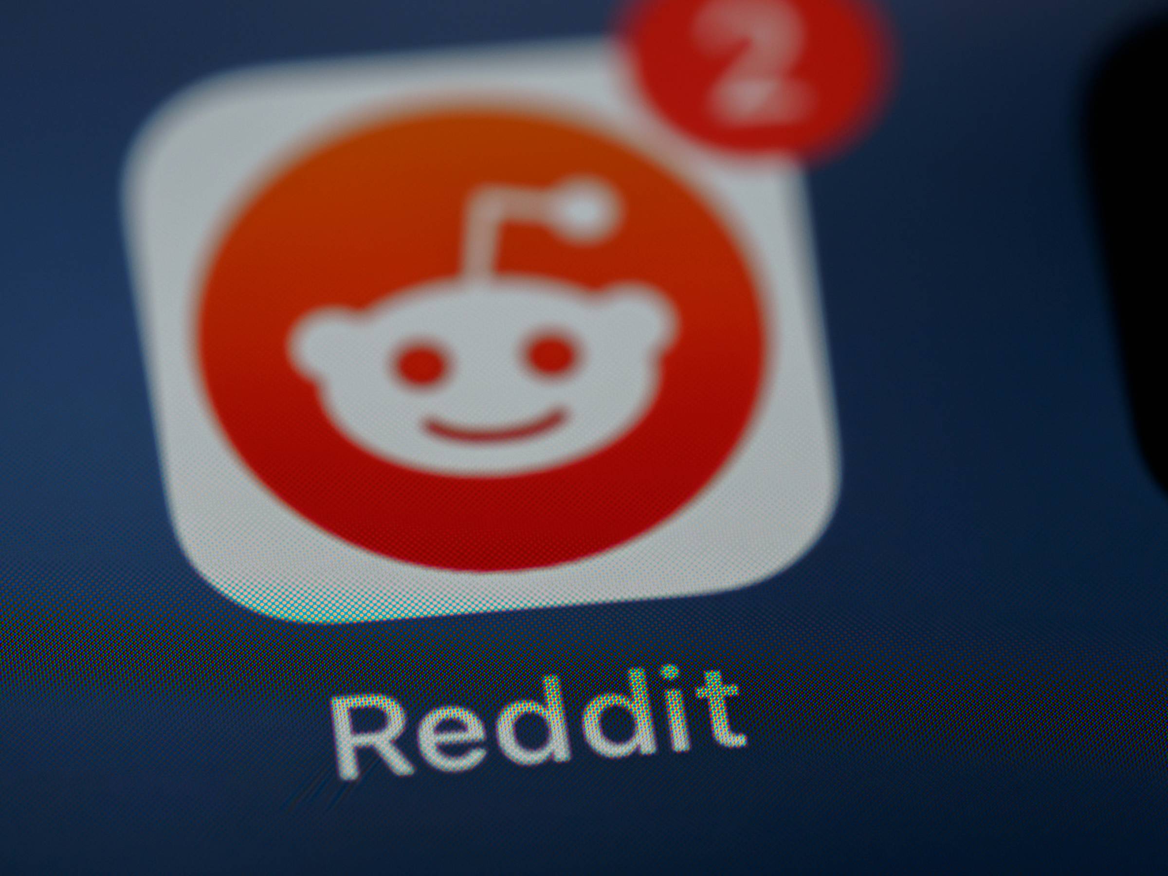 The Reddit app as it appears on a phone screen with two red message alerts