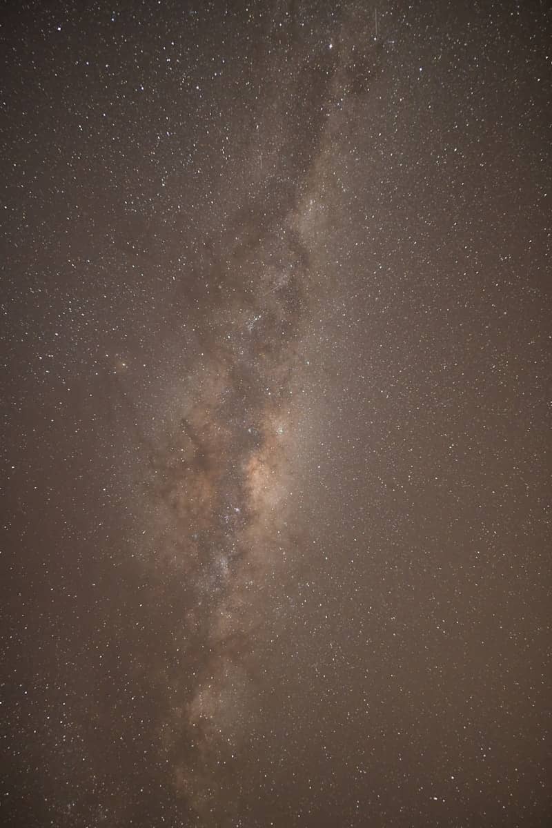 The Milky Way galaxy stretching across a dark night sky filled with stars.