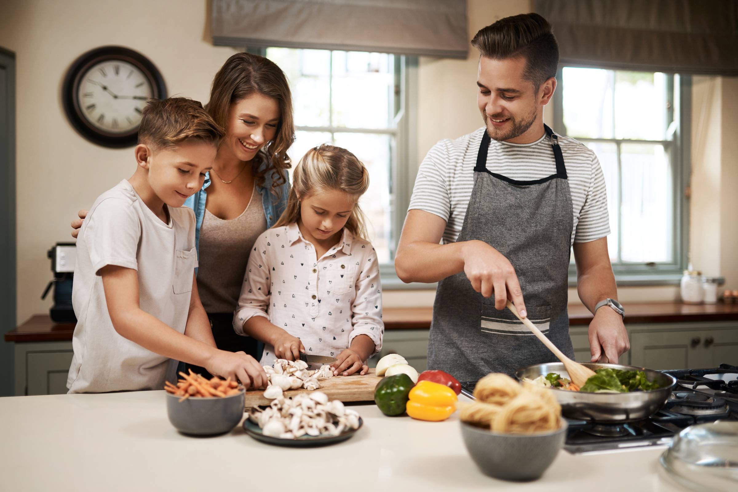 family of four cooking together