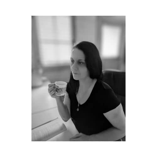 Woman with headset and necklace sitting at her desk