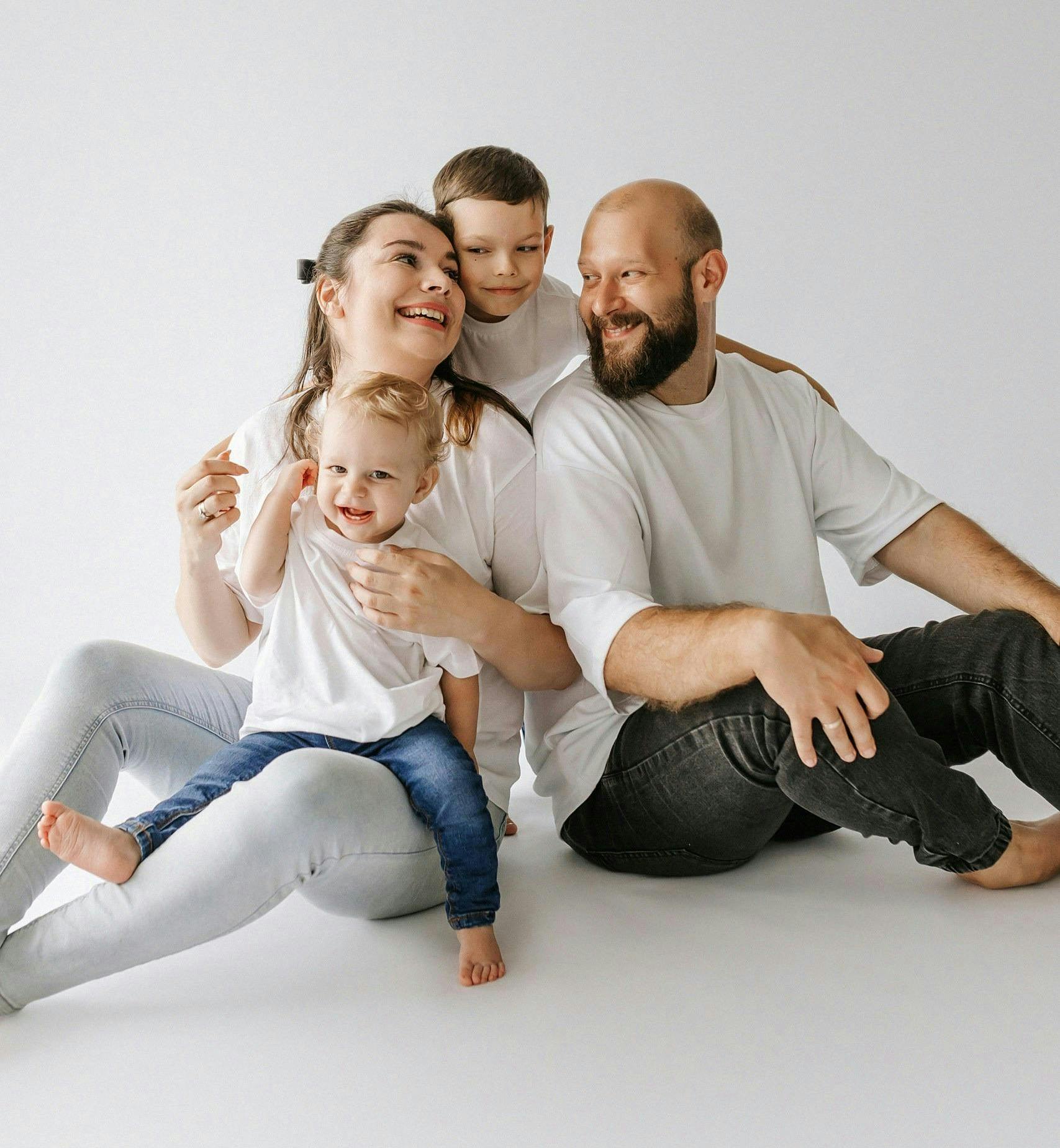 A laughing family with children sitting around. Image courtesy Pexels