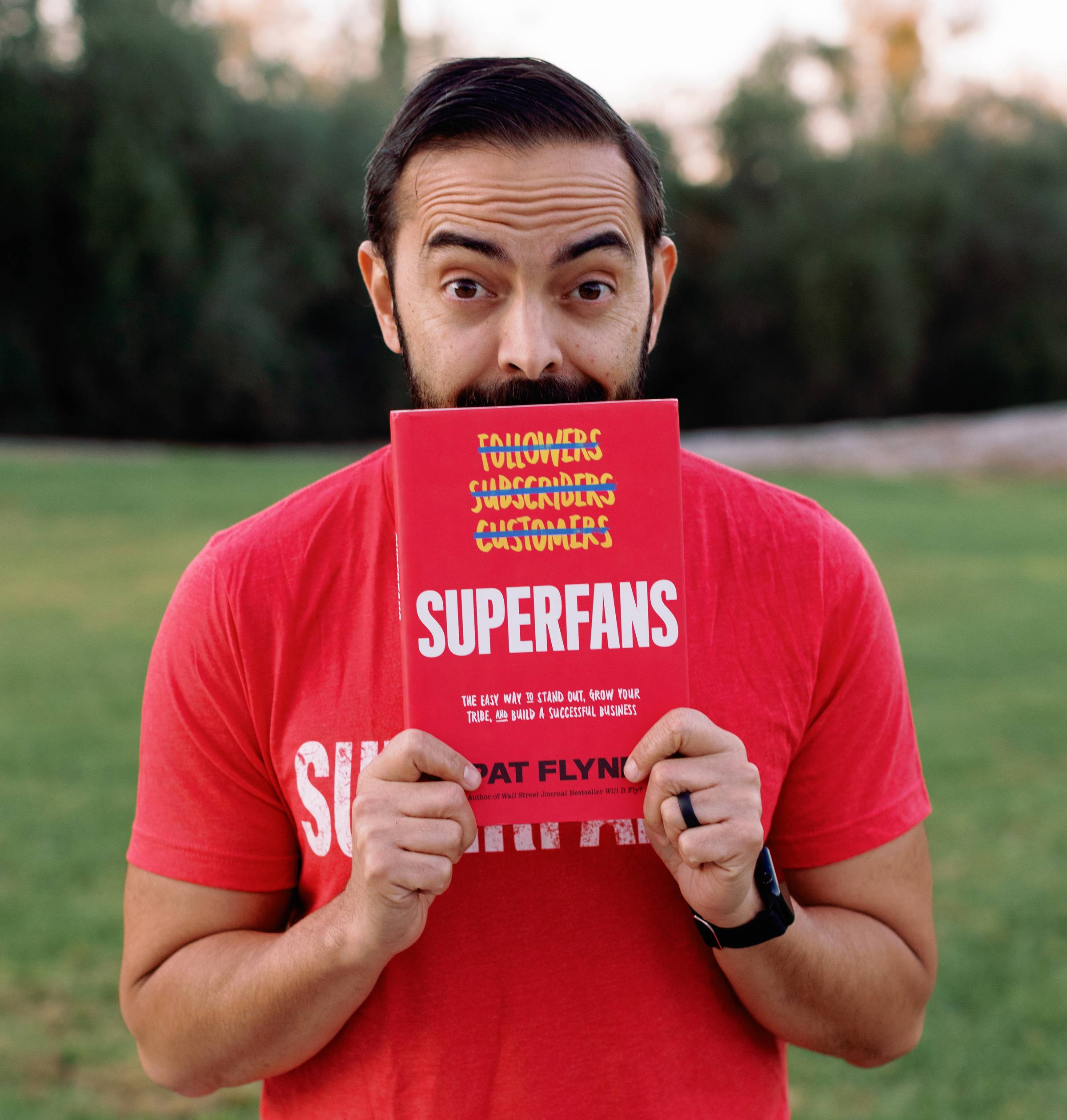 Pat Flynn holding his Superfans book
