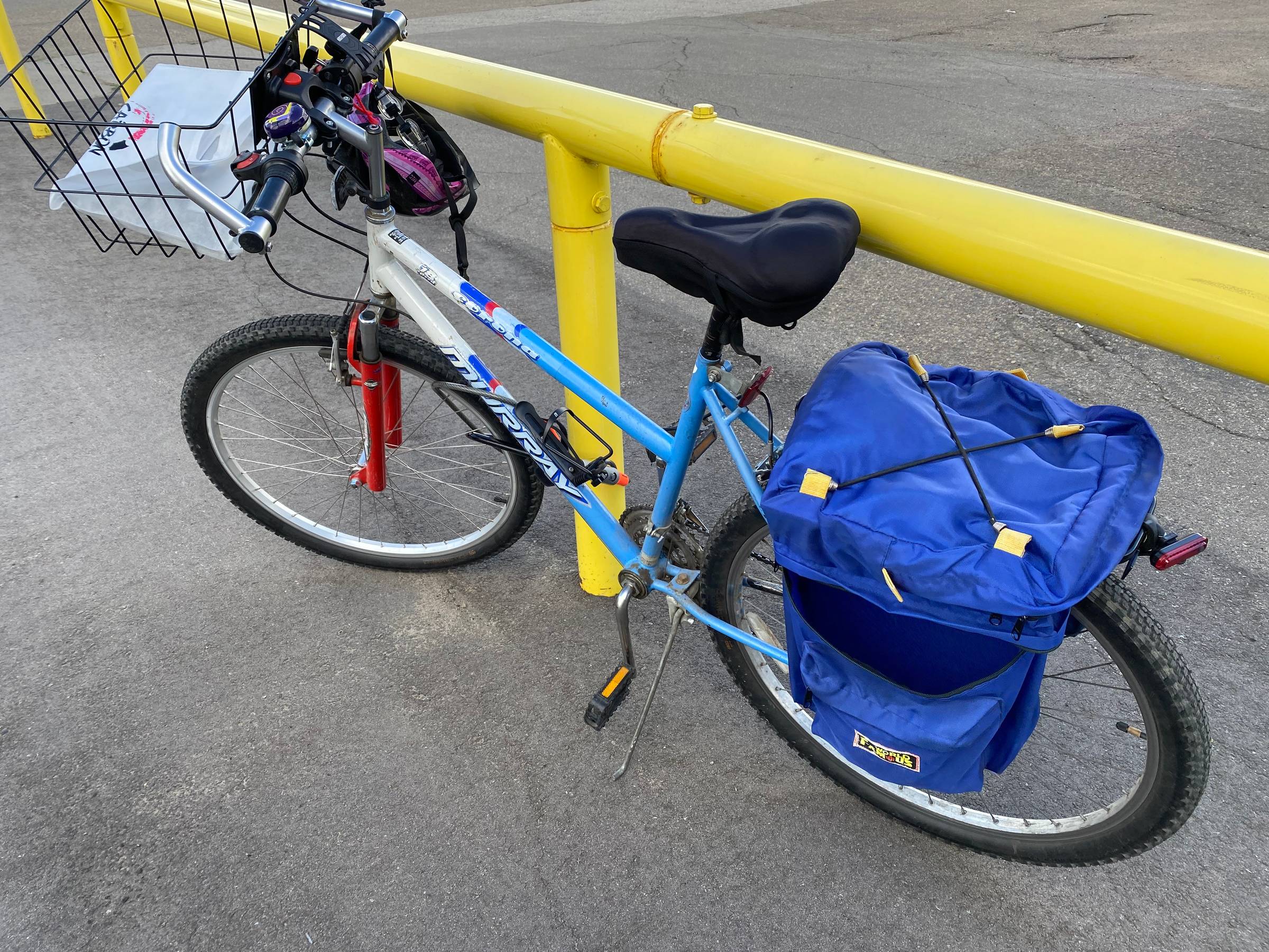 A bike with basket and saddlebags.