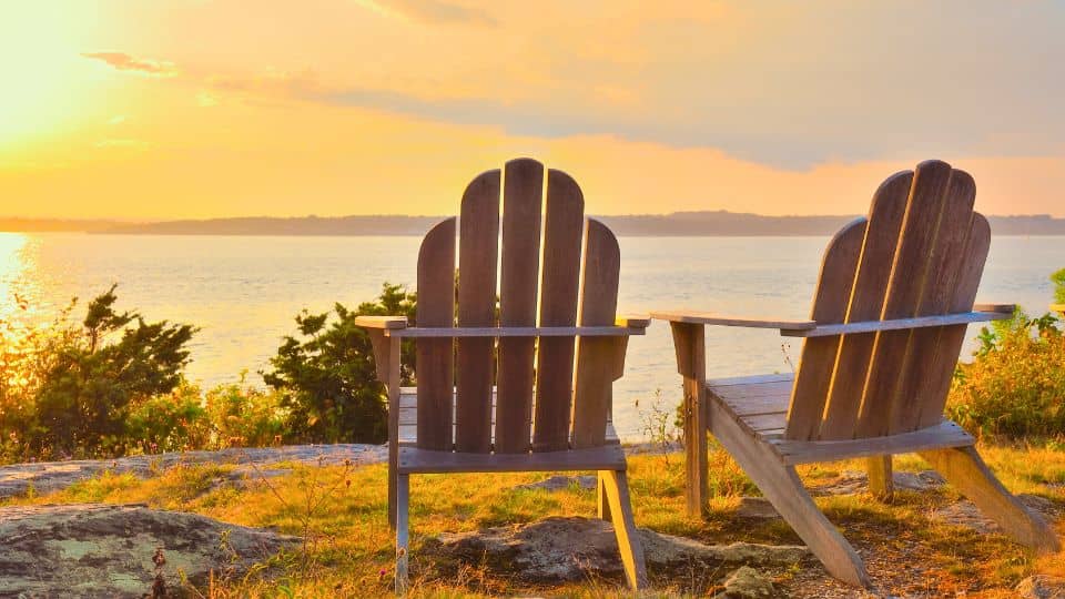 Two chairs at the beach during sunset