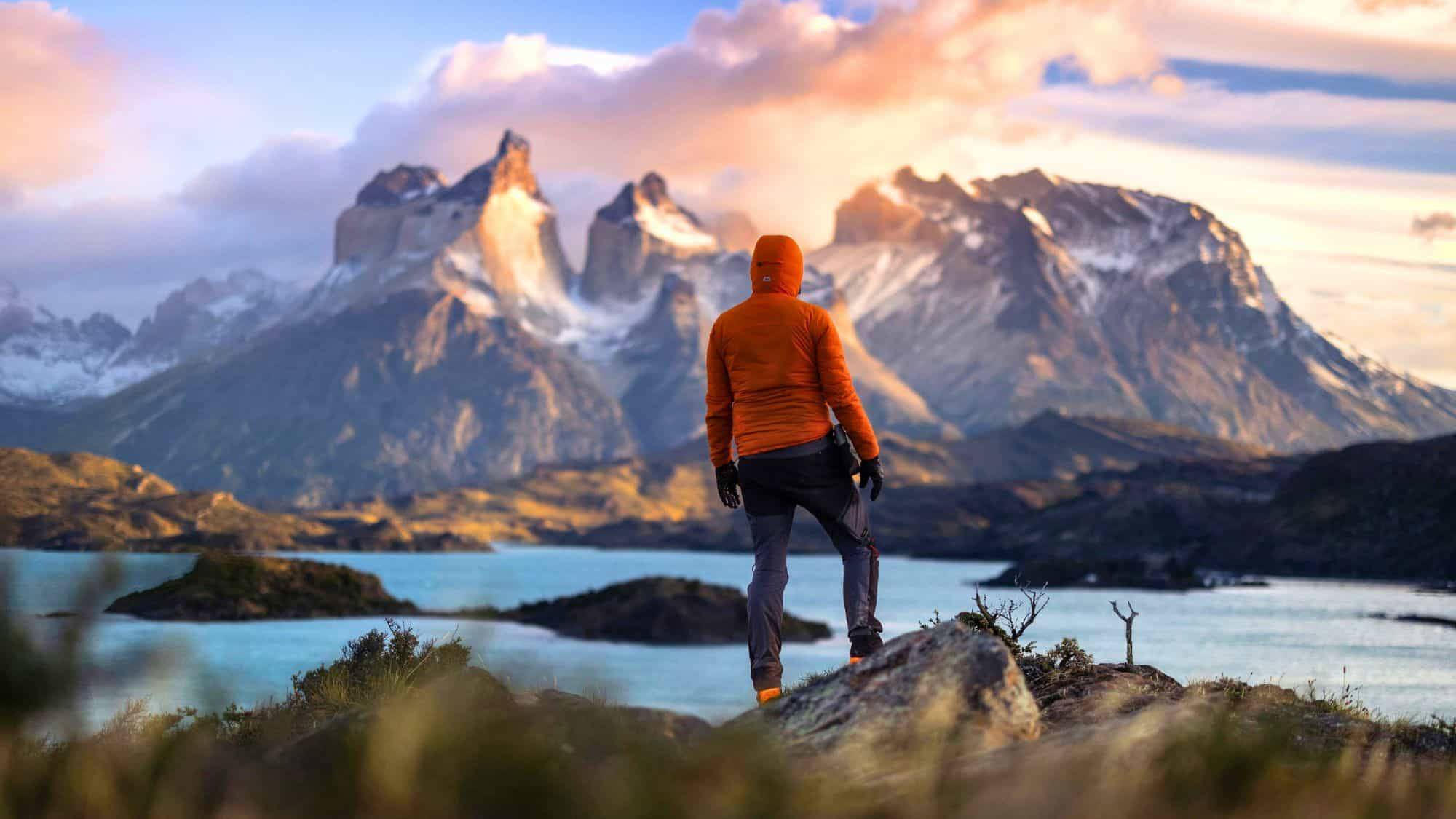 Person overlooking the mountains at sunset
