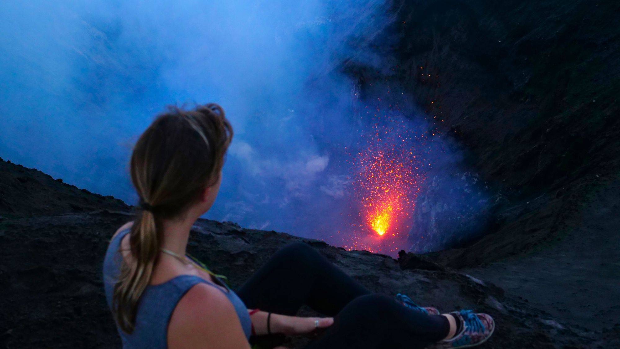 Women looking into a active volcano