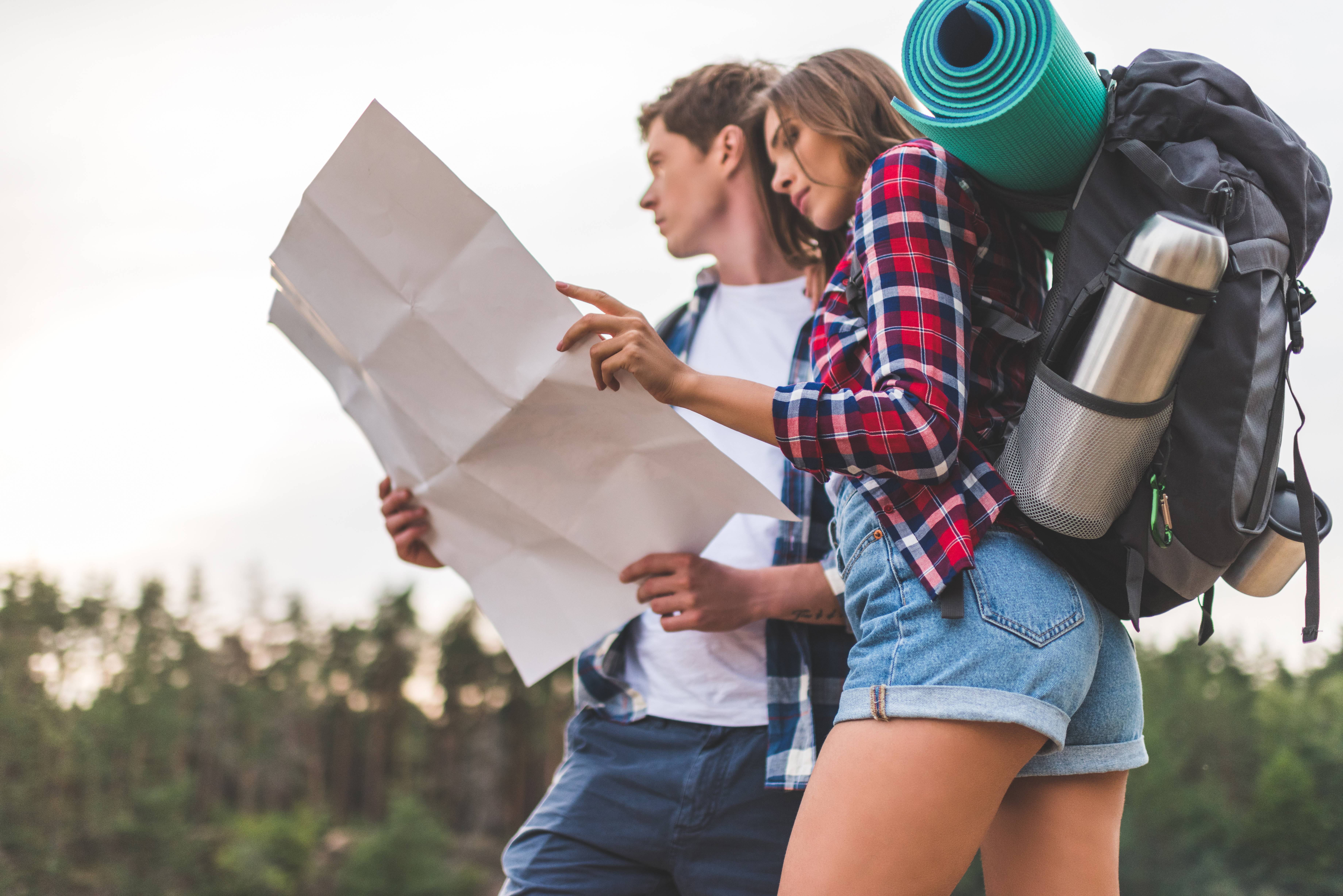 A hiking couple looking at a map.