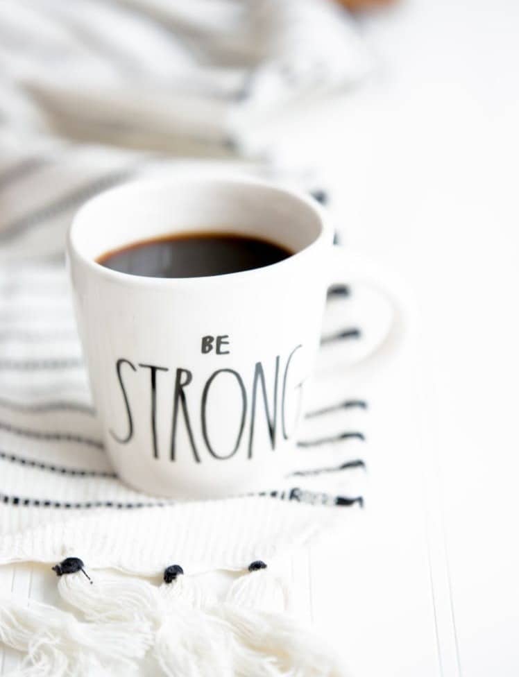 white ceramic mug filled with black coffee