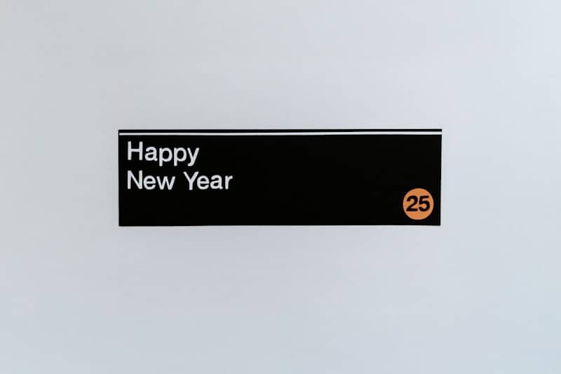 A sign that says happy new year hanging on a wall