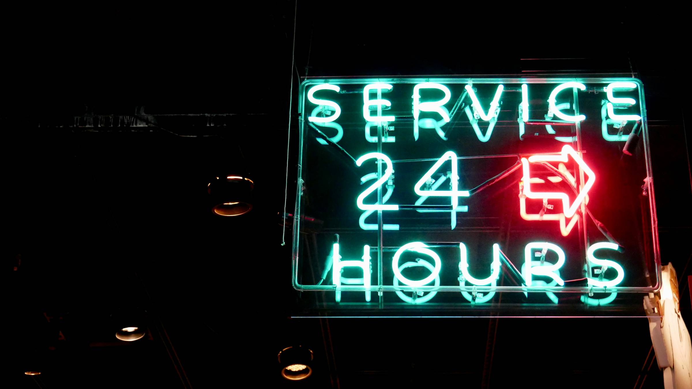 neon sign that reads "service 24 hours"