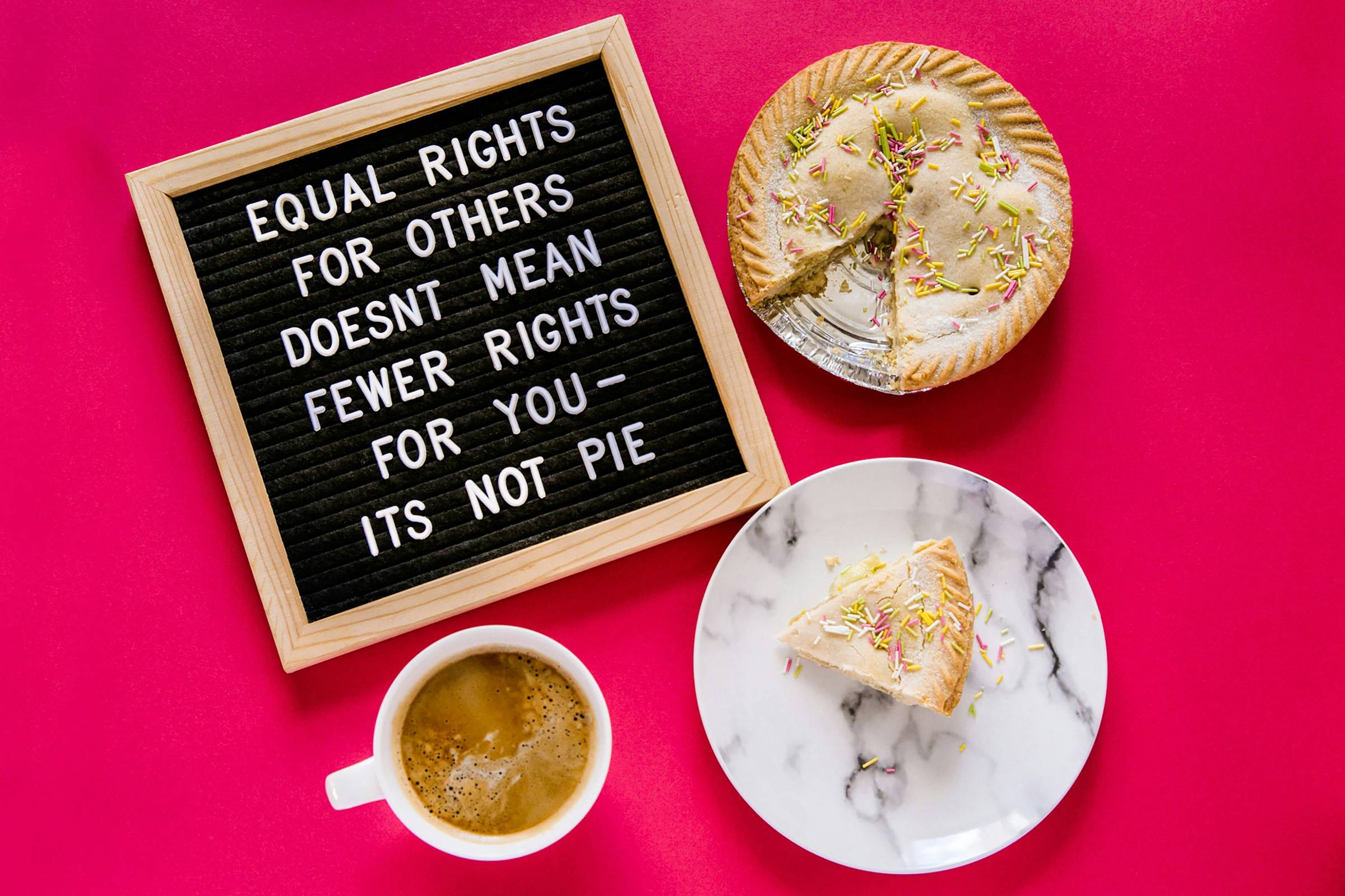 white ceramic mug and plate and sign that reads "equal rights for others doesn't mean fewer rights for you, it's not pie" all on a red background