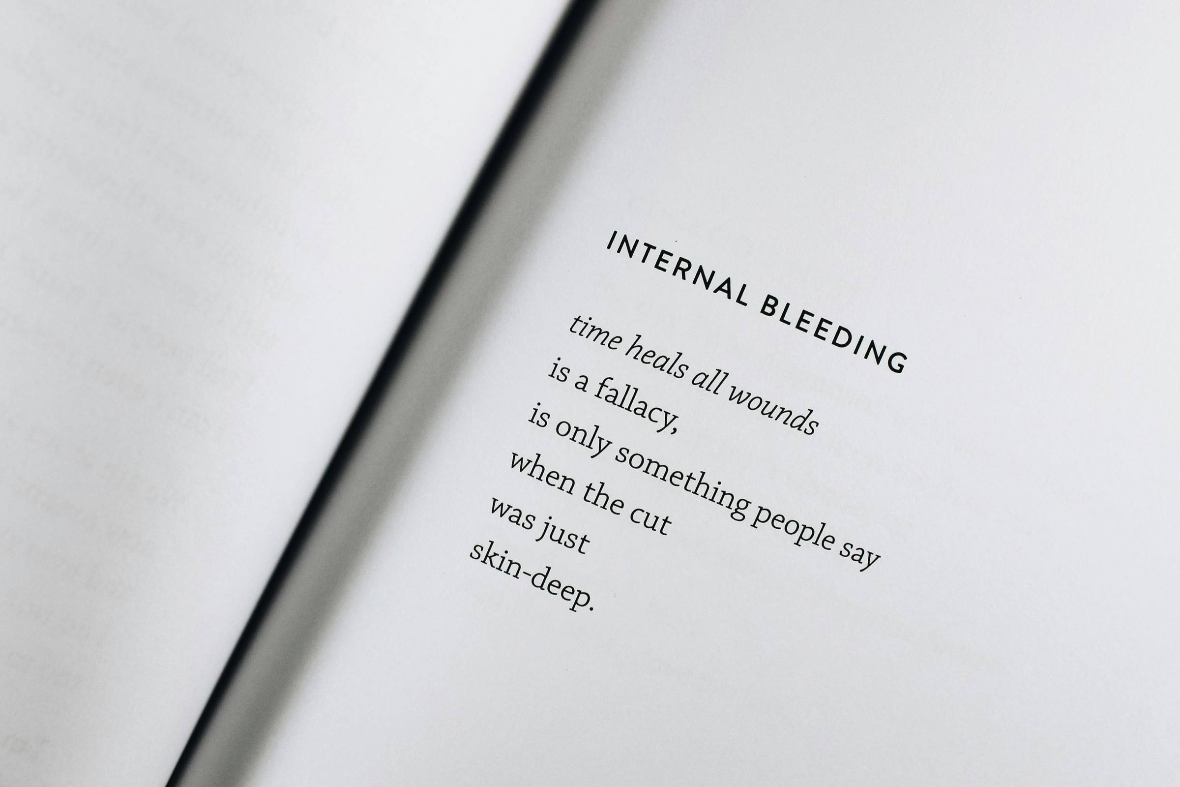 page of a book that reads: "Internal bleeding. Time heals all wounds is just a fallacy, is only something people say when the cut was just skin-deep".