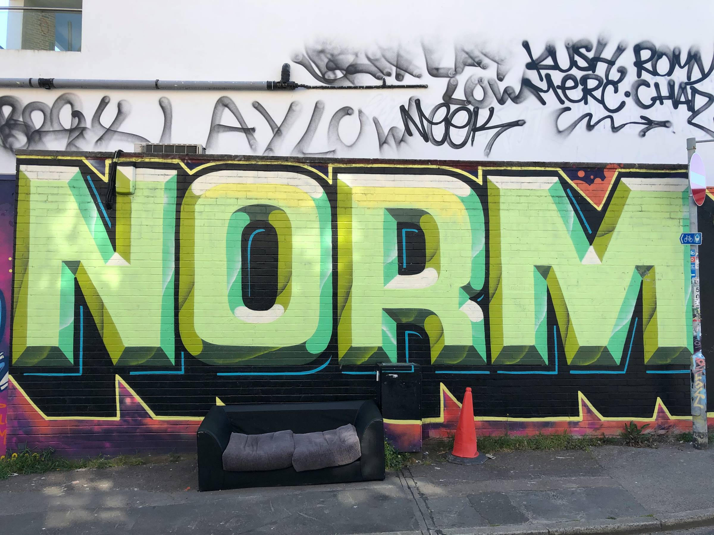 graffiti on a wall that reads the word norm