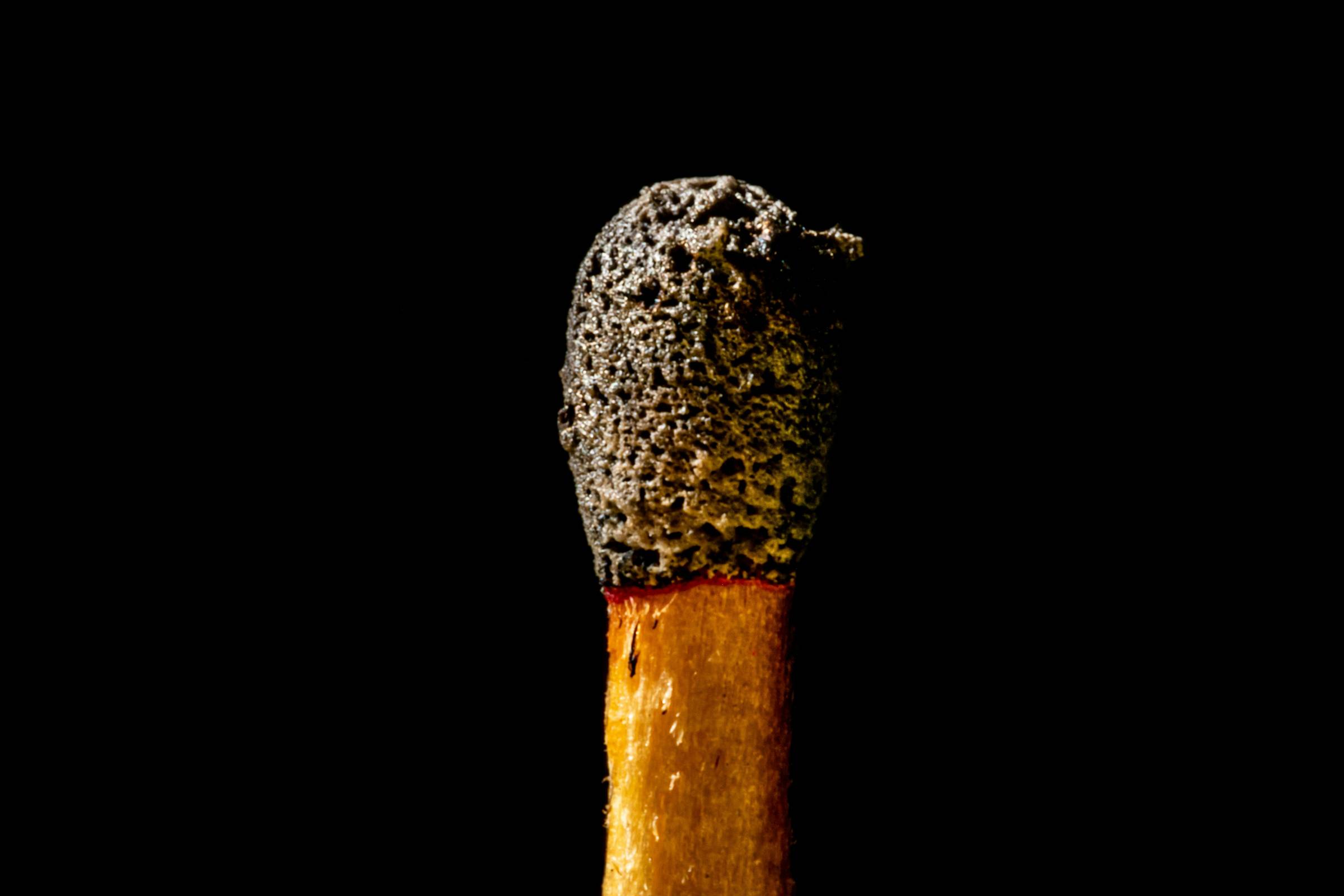 burnt matchstick on black background