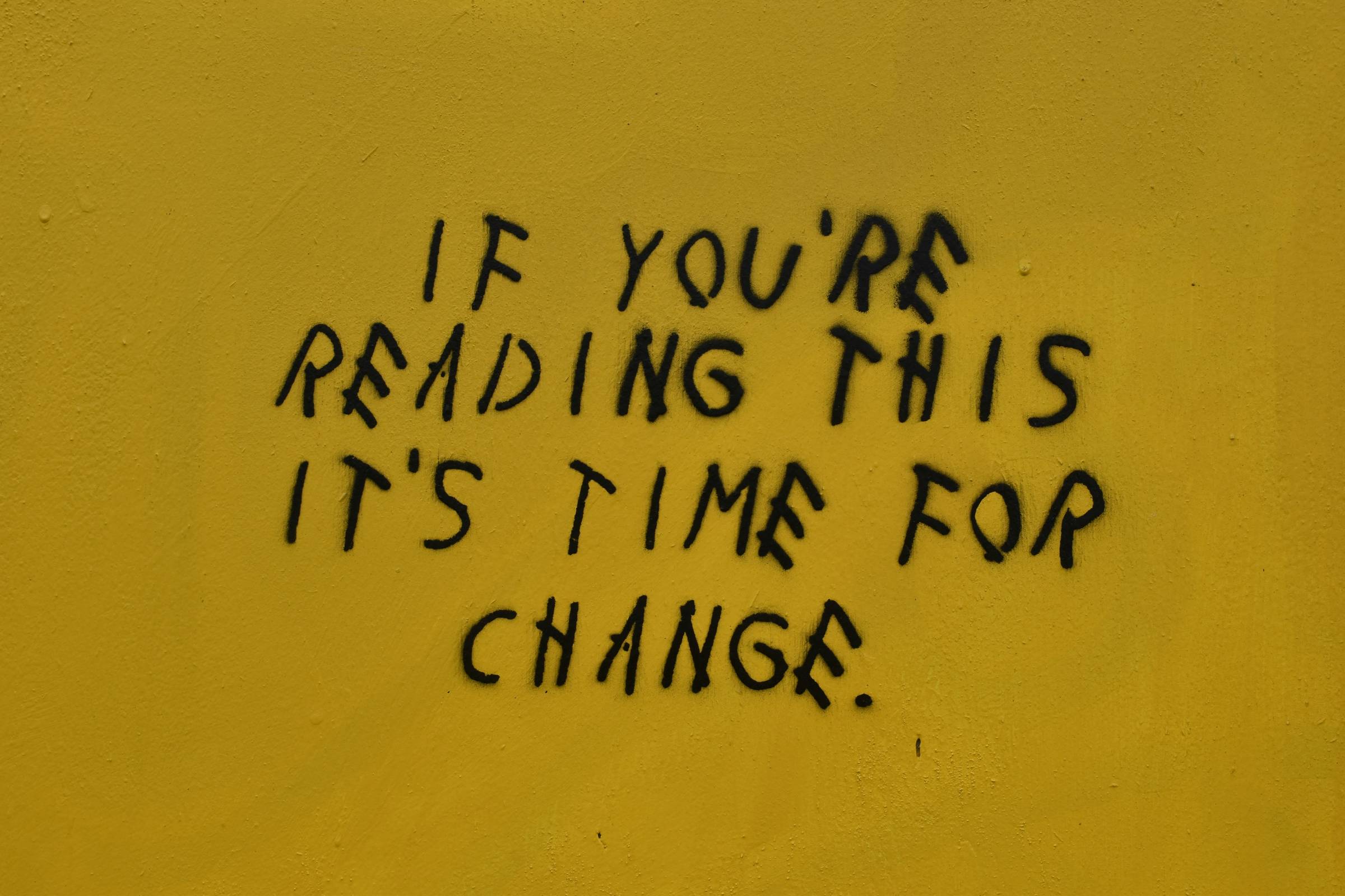 writing on wall that reads "if you're reading this it's time for change"