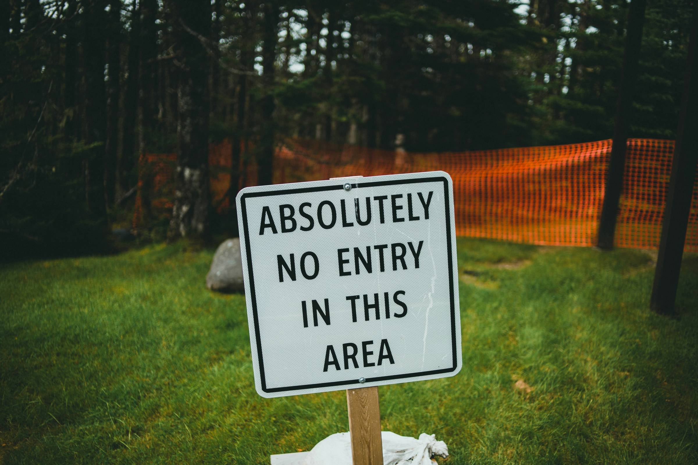 sign on grass that reads "absolutely no entry in this area"
