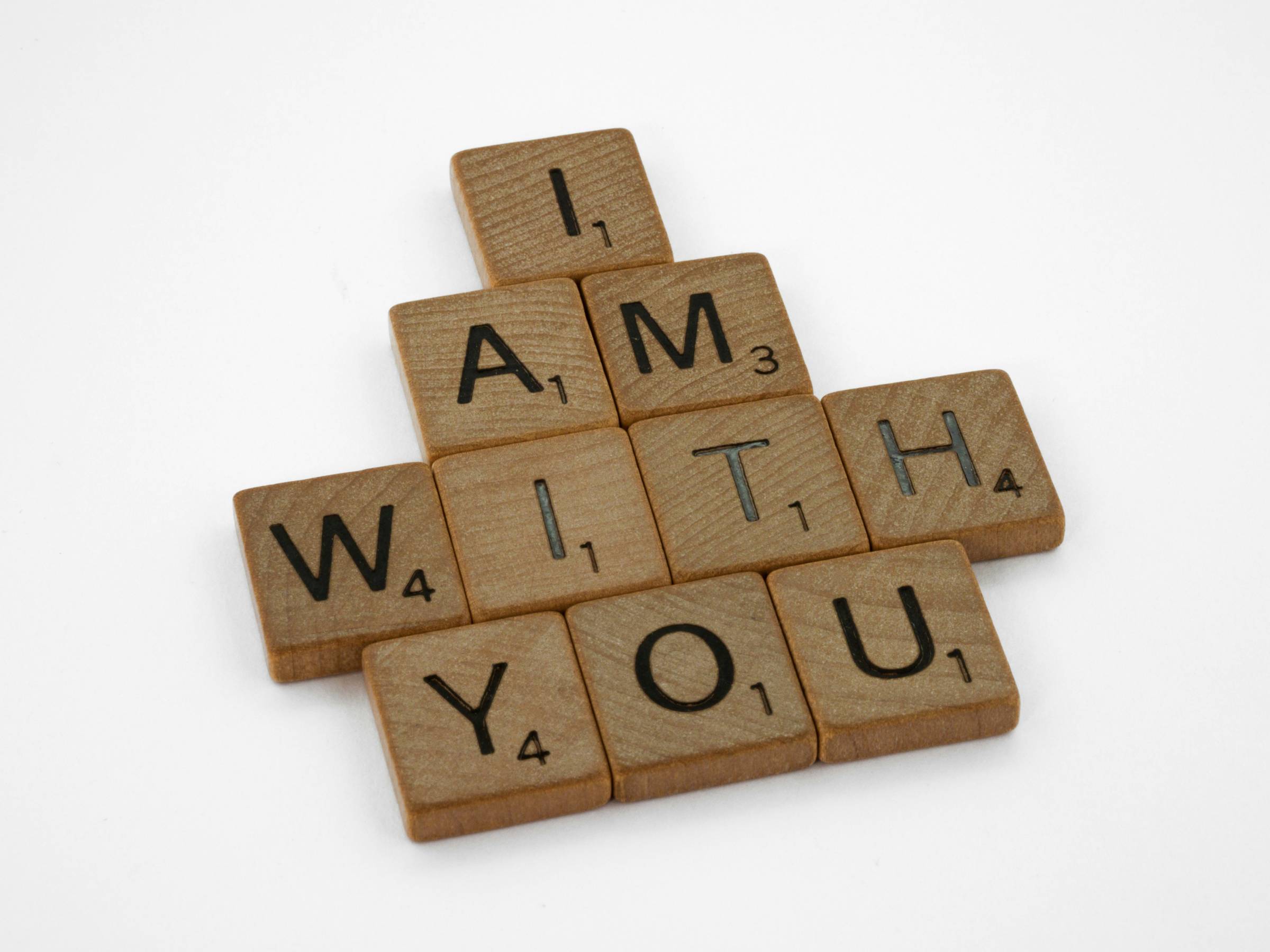 brown wooden blocks on a white background that reads "i am with you"