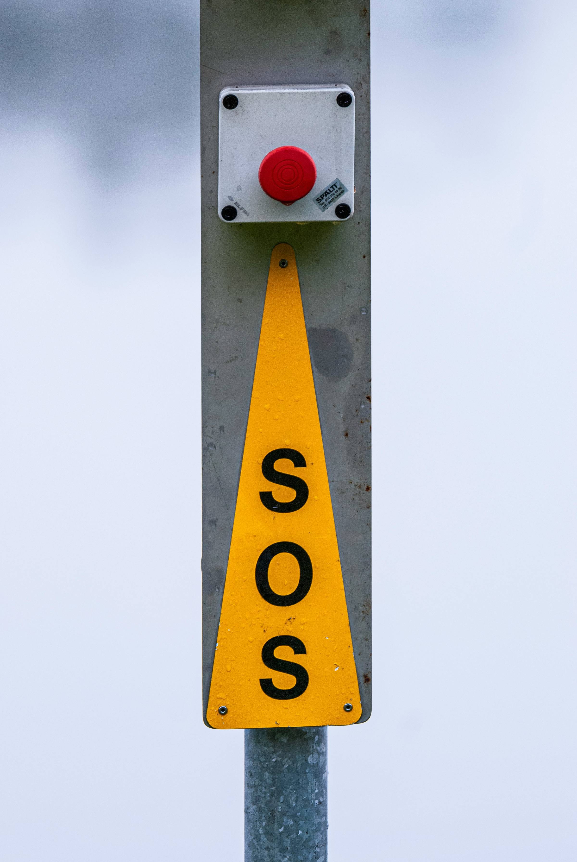 yellow and grey SOS sign and red button