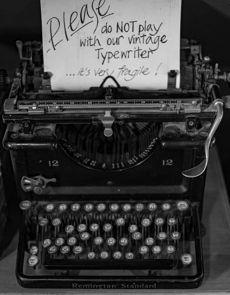 A black and white photo of an old fashioned typewriter