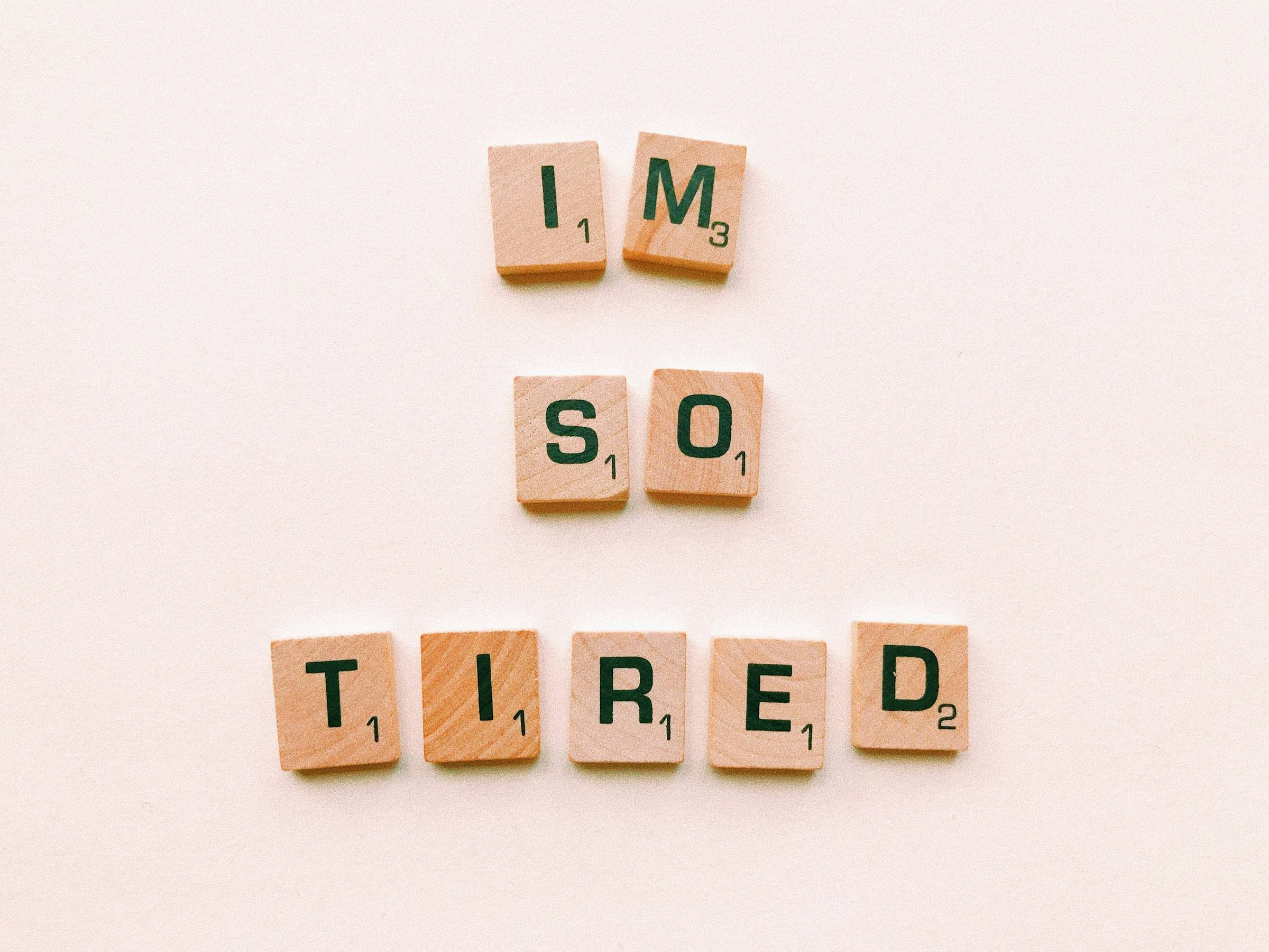 wooden block tiles with black font letters that read "i'm so tired"